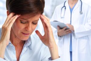 Woman having a migraine headache.