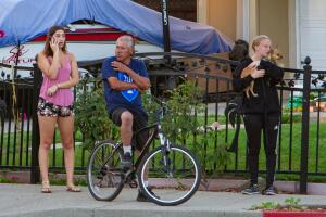 People look on from near the scene of a mass shooting during the Gilroy Garlic Festival in Gilroy, California