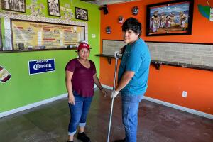 Juan Perez and Juana Tojil in Crazy Tacos, Port Charlotte, cleaning up after Ian.