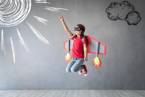 Happy child playing with toy jetpack