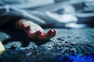 Extreme Close-Up on Victim's Bloody Hand. Still Dead Body Under a Cover and Next to Numbered Markers. Spilled Blood on the Floor Suggests a Violent and Shocking Crime of Passion in Urban City
