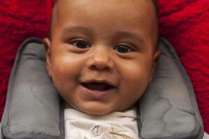 Portrait of a baby boy sitting in his car seat.