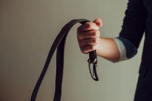 Man's hand with leather belt. Domestic violence and child abuse. Spanking concept. Problems and criminal in family.