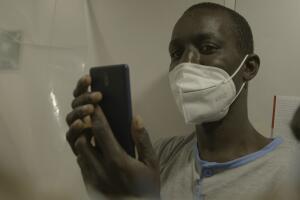 A man holds his phone up.jpg