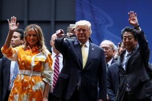 U.S. President Donald Trump, first lady Melania Trump and Japan's Prime Minister Shinzo Abe waves after delivering a speech to Japanese and U.S. troops as they aboard Kaga at JMSDF Yokosuka
