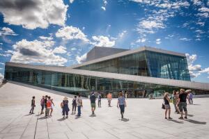 Tourists exploring Oslo Opera House, Norway