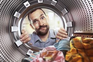 portrait of man view from washing machine inside