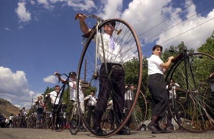 GOLDEN, CO - JULY 27: Marty Potts, of East Peoria, Illinois, and other members of The Wheelmen, an international organization that promotes the restoration and use of antique bicycles, line up to parade in honor of Buffalo Bill Days July 27, 2002 in Golden, Colorado. The Wheelmen's annual meet brought together more than 200 enthusiasts from as far as New Zealand for a week of riding in Colorado. (Photo by Kevin Moloney/Getty Images)