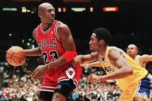 Michael Jordan of the Chicago Bulls (L) eyes the b