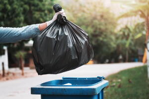 Hand,Holding,Garbage,Black,Bag,Putting,In,To,Trash