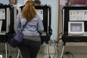 Votante en el distrito 6to de Georgia deposita su voto usando una máquina electrónica.