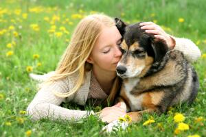 Woman Tenderly Hugging German Shepherd Dog