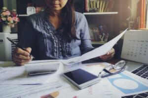 Budget planning concept, Accountant is calculate  tax. Calendar 2021 and personal income tax form for those who have income under US law placed on office desk.