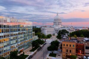 Bird's eye view of the Wisconsin state capital at sunset.  The building houses both chambers of the Wisconsin legislature along with Wisconsin Supreme Court .