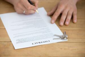 Close up view of male hands sign mortgage contract