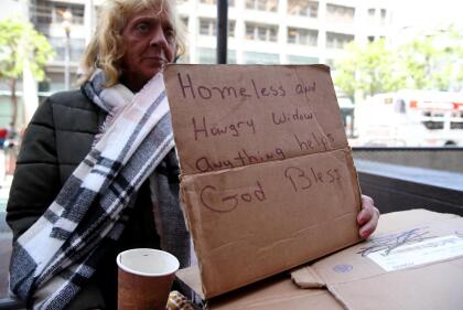 SAN FRANCISCO, CALIFORNIA - MAY 17: A homeless woman holds a sign as she begs for money on May 17, 2019 in San Francisco, California. Results of a two-year Homelessness Point-in-Time (PIT) Count show a 17 percent surge in homeless individuals in the city and county of San Francisco. 8,011 homeless people were counted in January of this year compared to 6,858 people in 2017. (Photo by Justin Sullivan/Getty Images)