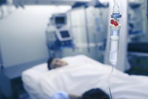 Woman is on duty at the bedside of the patient and sleeps at the post