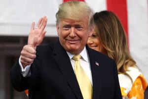 U.S. President Donald Trump, first lady Melania Trump react during delivering a speech to Japanese and U.S. troops as they aboard Japan Maritime Self-Defense Force's (JMSDF) helicopter carrier DDH-184