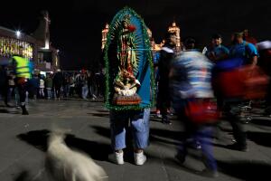 A man stands with an image of the Virgin of Guadalupe at the Basilica of Guadalupe during the annual pilgrimage in honor of the Virgin of Guadalupe, patron saint of Mexican Catholics, in Mexico City