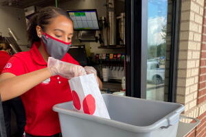 Chick-fil-A employee servicing at drive-through window