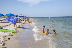 People relax at the Crandon Park beach