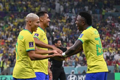 Brazil's forward #09 Richarlison (L) celebrates with Brazil's forward #20 Vinicius Junior (R) after scoring his team's second goal during the Qatar 2022 World Cup Group G football match between Brazil and Serbia at the Lusail Stadium in Lusail, north of Doha on November 24, 2022. (Photo by NELSON ALMEIDA / AFP) (Photo by NELSON ALMEIDA/AFP via Getty Images)