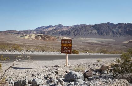 A heat advisory sign is shown along US highway 190 during a heat wave in Death Valley National Park in Death Valley, California, on July 16, 2023. Tens of millions of Americans braced for more sweltering temperatures Sunday as brutal conditions threatened to break records due to a relentless heat dome that has baked parts of the country all week. By the afternoon of July 15, 2023, California's famous Death Valley, one of the hottest places on Earth, had reached a sizzling 124F (51C), with Sunday's peak predicted to soar as high as 129F (54C). Even overnight lows there could exceed 100F (38C). (Photo by Ronda Churchill / AFP) (Photo by RONDA CHURCHILL/AFP via Getty Images)