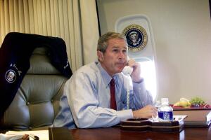 US President George W. Bush talks on the