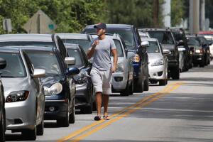 People in their vehicles wait in queue to get sandbags at Kissimmee, in preparation for the arrival of Hurricane Irma making landfall, in Florida