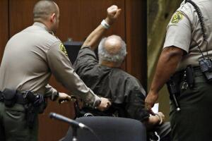LOS ANGELES, CA  SEPTEMBER 25, 2014 - A defiant convicted serial killer Samuel Little, 74, raises hi