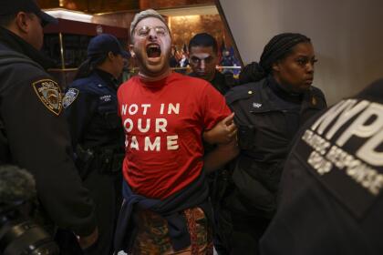 New York Police officers arrest a demonstrator from the group, Jewish Voice for Peace, who protested inside Trump Tower in support of Columbia graduate student Mahmoud Khalil, Thursday, March 13, 2025, in New York. (AP Photo/Yuki Iwamura)