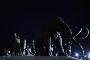 People examine bronze sculptures of mamm
