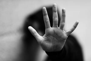 hand of the little girl who wants to protect herself with black