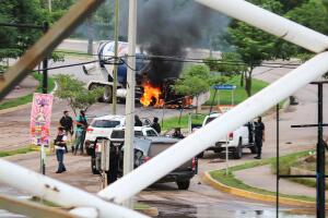 Cartel gunmen are seen near a burning truck  during clashes with federal forces following the detention of Ovidio Guzman, son of drug kingpin Joaquin "El Chapo" Guzman, in Culiacan