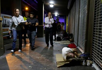 Marti Yeager, left, William Miranda, center, and Ron Book, chairman of the Homeless Trust, right, walk along a downtown street during the annual Point-in-Time count of the homeless in Miami-Dade County, Thursday, Jan. 26, 2017, in Miami. The count is mandated by the U.S. Department of Housing and Urban Development to help communities track progress toward the goal of ending homelessness. (AP Photo/Lynne Sladky)