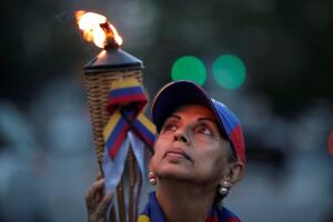 People attend a candlelight vigil held for victims of recent violence in Caracas