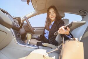 businesswoman, work, driving, multitasking, car, lifestyle concept. Businesswoman multitasking while driving car working and talking on cell phone on the road.