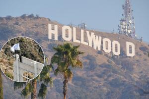 Hombre escala el letrero de Hollywood para ondear bandera publicitaria; fue detenido