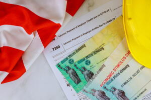 American flag on Stimulus financial relief check to the Passport of USA in hard hat