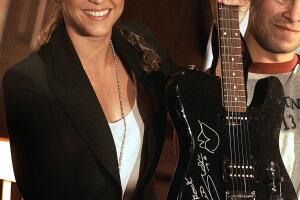 Colombian singer Shakira shows a guitar