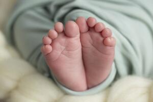 Children's sweet feet wrapped in a blanket
