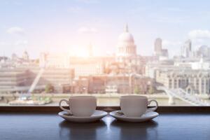 Two cups of coffee with panoramic view of a city