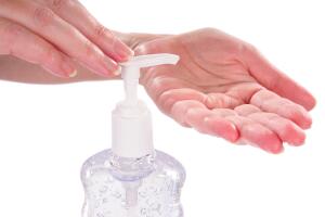 Woman sanitizing her hands with germ protection