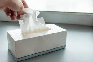 Hand picking white tissue paper