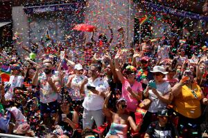 Confetti falls as people watch the 2019 World Pride NYC and Stonewall 50th LGBTQ Pride parade in New York