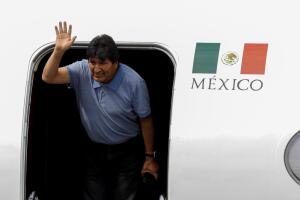 Bolivia's ousted President Evo Morales waves during his arrival to take asylum in Mexico, in Mexico City