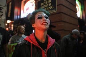 A counter protester wears a "Joker" mask after a rally by U.S. President Donald Trump in Minneapolis, Minnesota