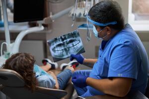 Dentist holding an x-ray picture of teeth