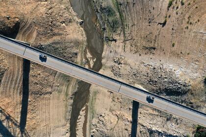 OROVILLE, CALIFORNIA - JULY 22: In an aerial view, the Enterprise Bridge crosses over a section of Lake Oroville that was previously underwater on July 22, 2021 in Oroville, California. As the extreme drought emergency continues in California, Lake Oroville's water levels are continuing to drop to 28 percent of capacity. State water officials say that Lake Oroville's Edward Hyatt Powerplant might be forced to shut down the hydroelectric plant as soon as August or September if water levels continue to drop. (Photo by Justin Sullivan/Getty Images)