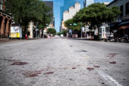 AUSTIN, TX - JUNE 12: The street is stained with blood near the scene of a shooting on June 12, 2021 in Austin, Texas. At least 13 people were taken to hospitals after a shooting happened on Austin's famous 6th Street. The shooter is still at large. (Photo by Sergio Flores/Getty Images)